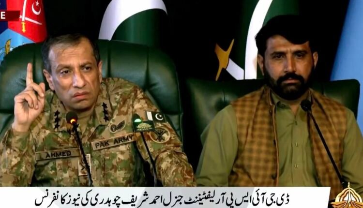 Pakistan military spokesperson Lt Gen Ahmed Sharif Chaudhry presents retired SSG soldier Muhammad Asif before journalists during a press briefing in Rawalpindi.
